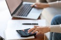 Businesswoman using calculator and laptop for budget cost management, closeup Royalty Free Stock Photo