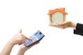 Businesswoman using a calculator and wooden house on white background, Accountants calculating profit and Interest rates concept