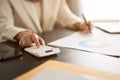 A businesswoman using a calculator, working on business financial reports at her desk. close-up Royalty Free Stock Photo