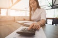 businesswoman using calculator at workplace. young female entrepreneur woman working with business document at office. analytic f