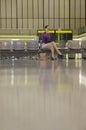 Businesswoman Using Cellphone In Airport Lobby