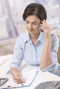 Businesswoman using cellphone in office Royalty Free Stock Photo