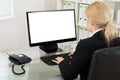 Businesswoman Using Computer At Desk Royalty Free Stock Photo