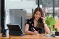 Businesswoman using computer tablet and talking on mobile phone with business partner. Royalty Free Stock Photo