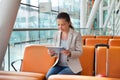 Businesswoman using digital tablet at airport lobby