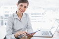 Businesswoman using digital tablet smiling at camera Royalty Free Stock Photo