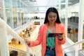 Businesswoman using digital tablet while walking on stairs Royalty Free Stock Photo