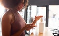 Businesswoman using hand sanitizer before entering office