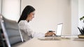 A businesswoman using her laptop computer in a meeting room Royalty Free Stock Photo