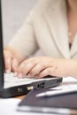 Businesswoman using her laptop inside office