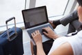 Businesswoman Using Laptop In Airport Departure Lounge Royalty Free Stock Photo