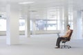 Businesswoman Using Laptop On Chair In Office Royalty Free Stock Photo