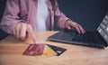 Businesswoman using laptop & choosing the best credit card. young girl shopping online, ordering, paying with many credit card, e- Royalty Free Stock Photo