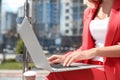 Businesswoman using laptop on city street Royalty Free Stock Photo