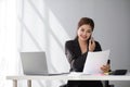 Businesswoman using laptop and mobile phone talking about work and managing company business Royalty Free Stock Photo