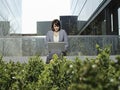 Businesswoman Using Laptop Outside Buildings Royalty Free Stock Photo