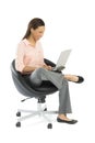 Businesswoman Using Laptop While Sitting On Office Chair Royalty Free Stock Photo