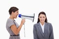 Businesswoman using megaphone to yell at colleague Royalty Free Stock Photo