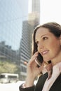 Businesswoman Using Mobile Phone Against Building Royalty Free Stock Photo