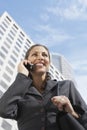 Businesswoman Using Mobile Phone Against Building Royalty Free Stock Photo