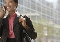 Businesswoman Using Mobile Phone Against Building Royalty Free Stock Photo