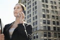 Businesswoman Using Mobile Phone Against Building Royalty Free Stock Photo