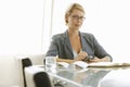 Businesswoman Using Mobile Phone At Conference Table Royalty Free Stock Photo