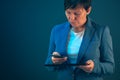 Businesswoman using mobile phone and tablet computer Royalty Free Stock Photo