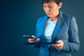 Businesswoman using mobile phone and tablet computer Royalty Free Stock Photo