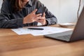 Businesswoman using mobile phone while working on business document and laptop on the table in office Royalty Free Stock Photo