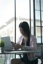 A businesswoman using mobile smart phone and working on laptop computer for browsing internet. Royalty Free Stock Photo