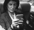 Businesswoman Using Smart Phone Car Inside Royalty Free Stock Photo