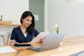 Businesswoman using stylus pen signing contract on digital tablet on office table. Business manager proofing e-document Royalty Free Stock Photo