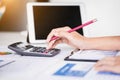 Businesswoman using tablet computer and calculator for calculating financial documents. Accounting,Finances and economy concept. Royalty Free Stock Photo