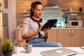Businesswoman using tablet pc in home kitchen Royalty Free Stock Photo