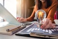 Businesswoman using tabtop computer and holding light bulb, with idea. Royalty Free Stock Photo