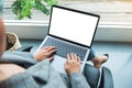 A businesswoman using and typing on laptop computer with blank white desktop screen in office Royalty Free Stock Photo