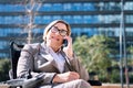 businesswoman using wheelchair talking on phone