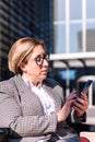 businesswoman using wheelchair typing on mobile