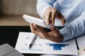 The businesswoman is using a white calculator to check company financial information, she is checking company financial Royalty Free Stock Photo