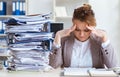 Businesswoman very busy with ongoing paperwork