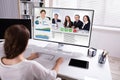 Businesswoman Video Conferencing With Colleagues On Computer
