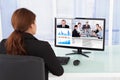 Businesswoman video conferencing with team on computer