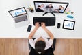 Businesswoman Videoconferencing With Co-workers On Computers Royalty Free Stock Photo