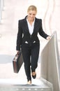 Businesswoman walking upstairs with briefase