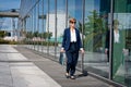 Businesswoman walks next to office building Royalty Free Stock Photo