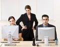 Businesswoman watching co-workers work Royalty Free Stock Photo