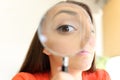 Businesswoman watching you with magnifier glass Royalty Free Stock Photo