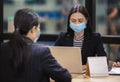 Businesswoman wear masks protect against airborne disease and salivary infections, during outbreak of Covid 19 virus, working with