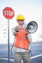 Businesswoman wearing builders clothes pointing at camera Royalty Free Stock Photo
